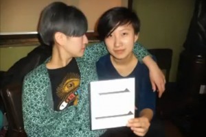 Two Chinese youth holding up the Chinese character for "2" in a Death to Giants music video.